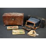An antique tea caddy together with a Kodak folding camera case.