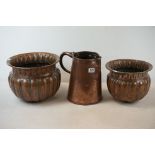 Two early 20th century copper planters together with a large copper jug.