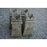 A set of four matching chimney pots, stand approx 75cm in height.