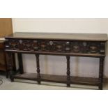 Oak Dresser Base in the 17th century manner, the three drawers with raised moulded geometric panels,