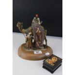 Cold Painted Spelter Match Striker in the form of a Camel with Arabs, 19cms high together with a
