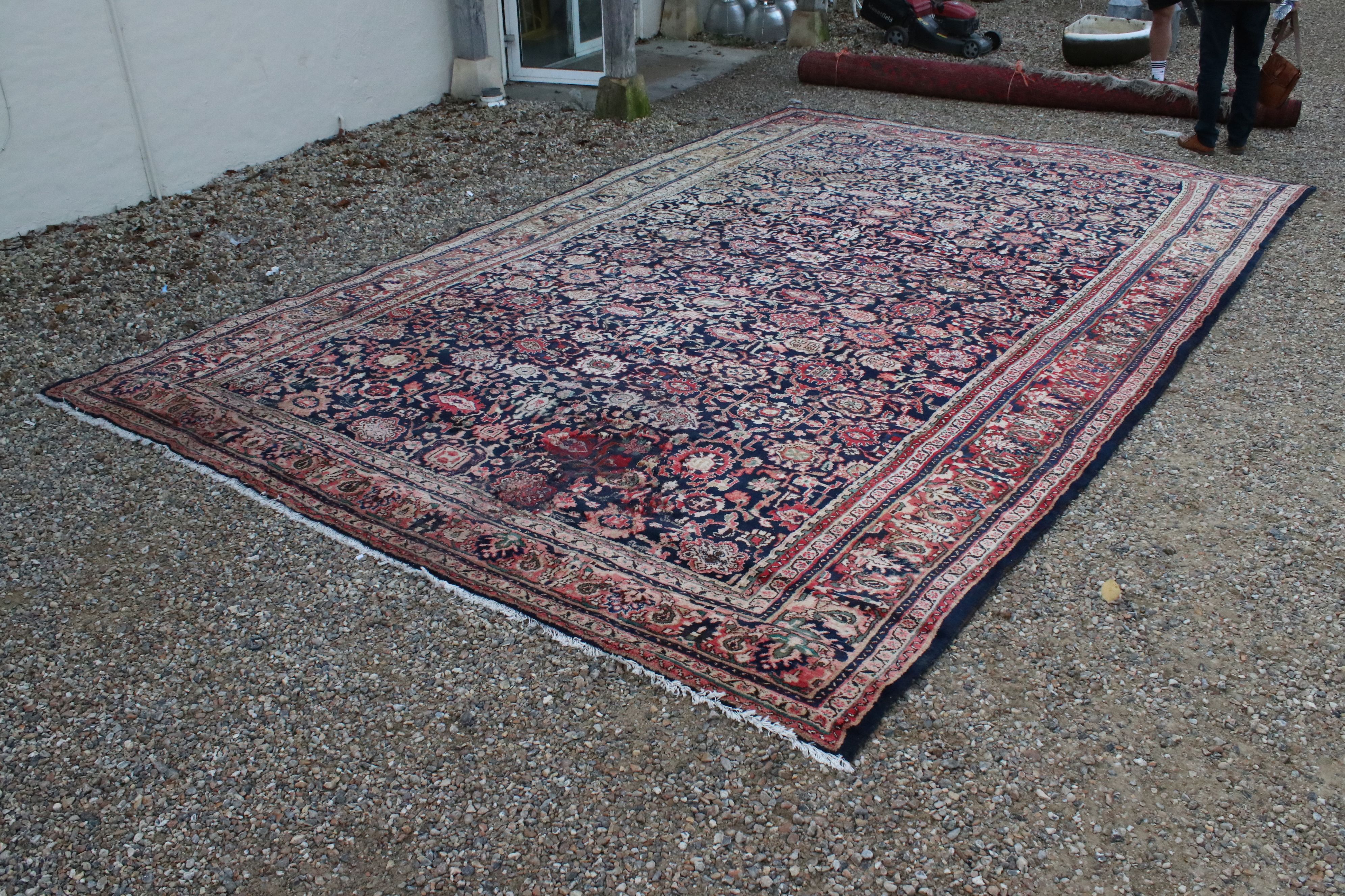 Large Wool Rug, multi coloured pattern on a blue ground within a border, 528cms x 310cms