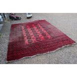 Large Wool Red Ground Rug with geometric pattern within a wide border, 417cms x 313cms