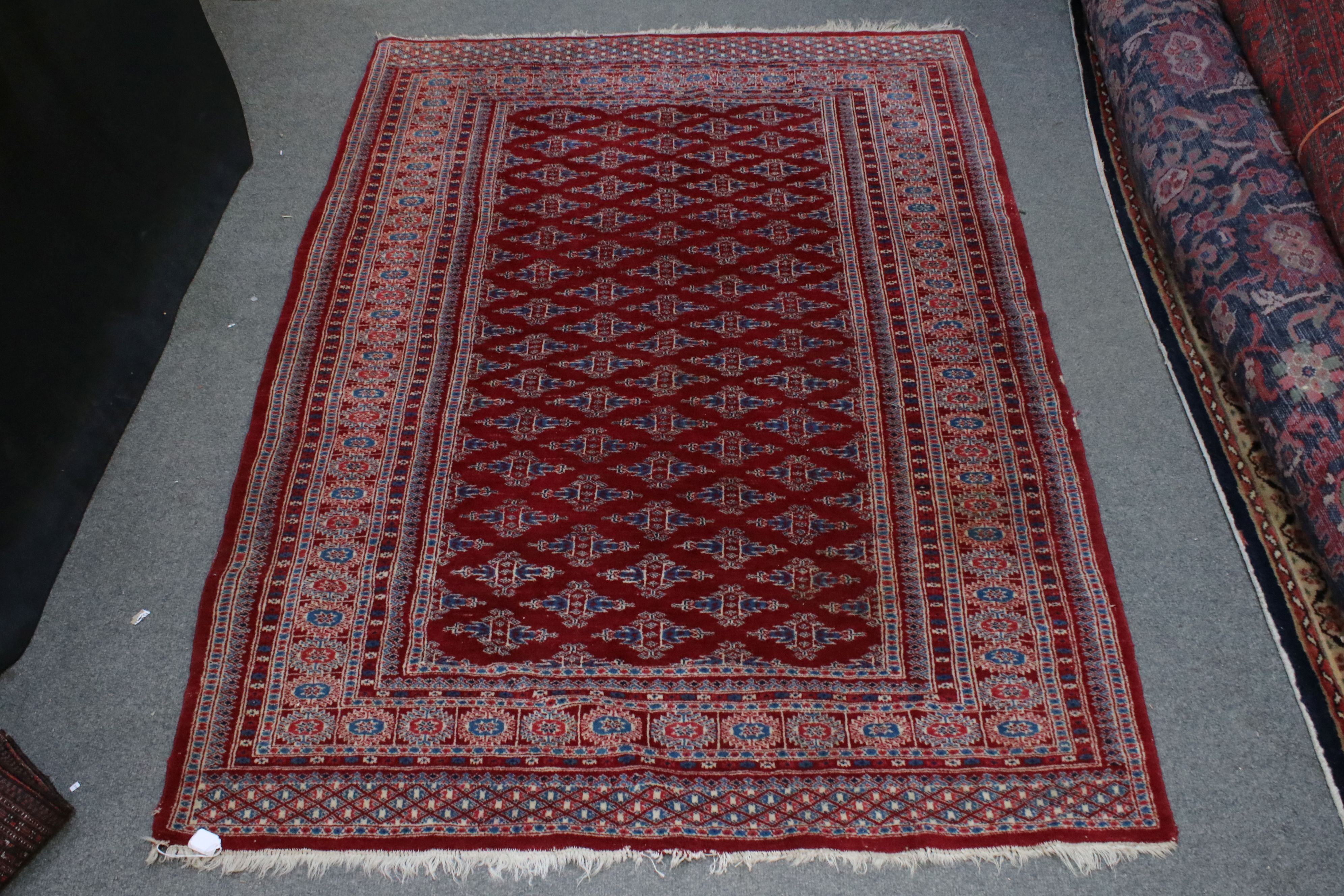 Eastern Red Ground Rug with Geometric pattern with a border, 184cms x 130cms