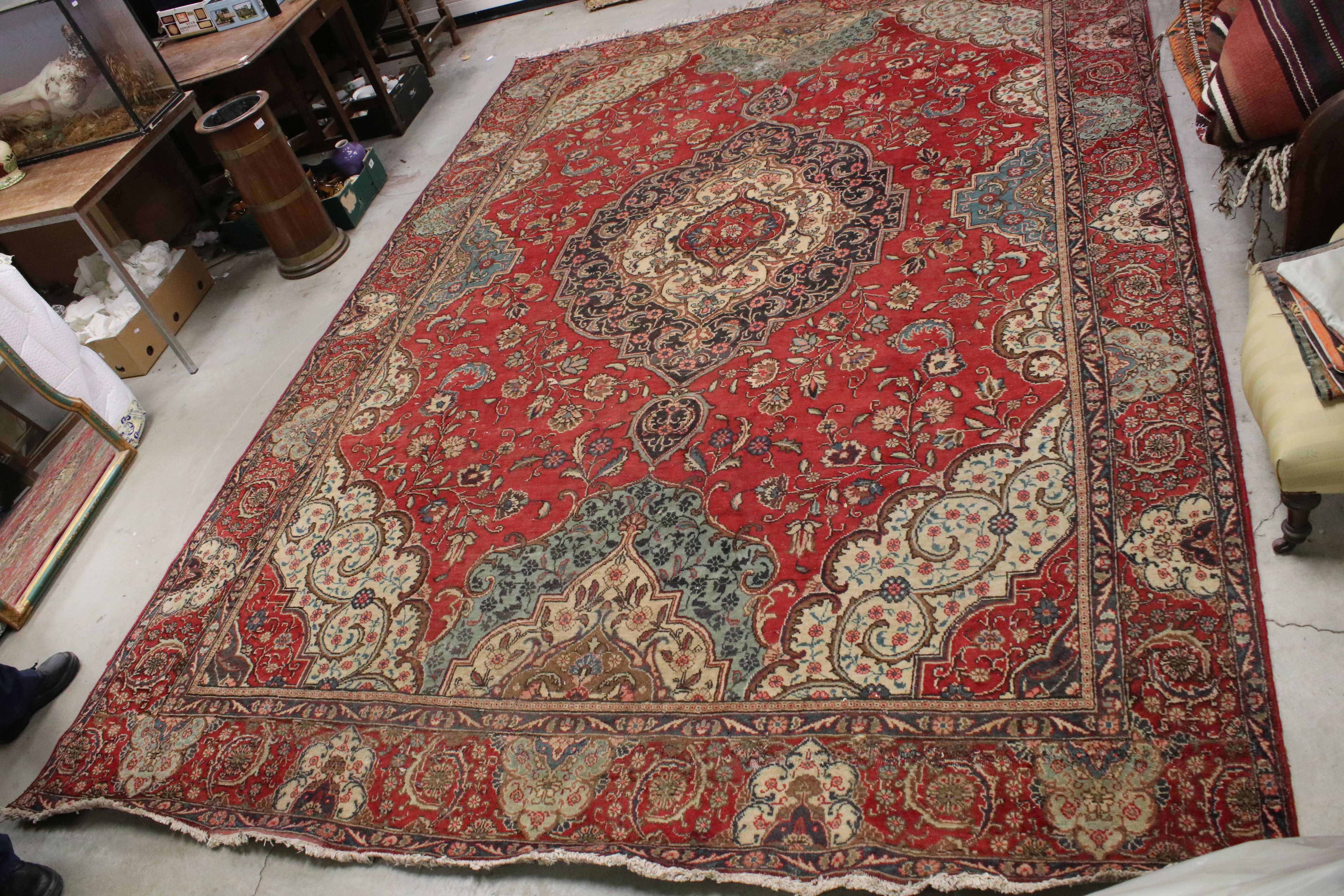 Large Wool Red Ground Rug with floral pattern within a border, 279cms x 396cms