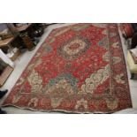 Large Wool Red Ground Rug with floral pattern within a border, 279cms x 396cms