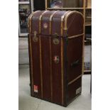 Early 20th century Wooden Bound and Canvas Covered Travelling Wardrobe, the hinged domed top and