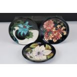 Three Moorcroft Pin Dishes in the Sea Holly, Oberon and Sophie Christina patterns, all on blue