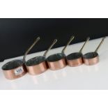 Set of Five Copper Graduating Saucepans with brass handles