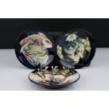 Three Moorcroft Pin Dishes in the Minuet, Quiet Waters and Lamia patterns, all on blue ground, 12cms