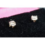 Pair of 14ct white gold diamond stud earrings of 1/2ct total weight