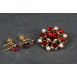 A ladies 9ct gold garnet and seed pearl closed back brooch together with a matching pair of screw