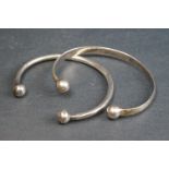 Two ladies sterling silver open ball ended bangles.