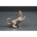 Silver figure of a cat with emerald eyes