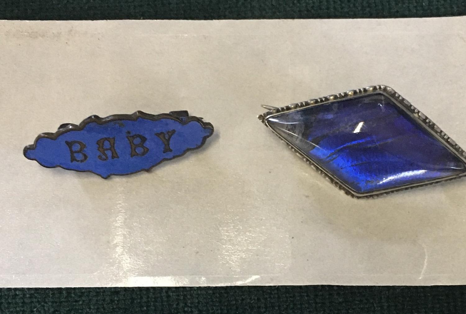 Sterling silver Art Deco brooch set with blue stone and a similar period enamel brooch with the word