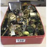 Tin containing various items including watches, costume jewellery, un-sorted