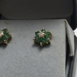 Pair of 18ct gold emerald and diamond ladies earrings, the centre diamond set surrounded by 5