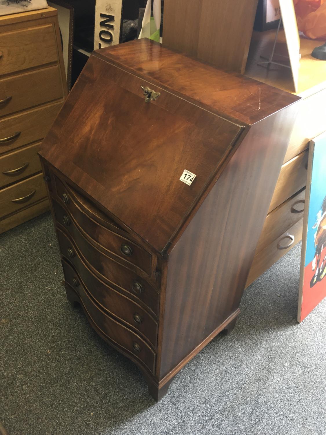 Mahogany Serpentine fronted Ladies Bureau with a fall front revealing a writing area and fitted