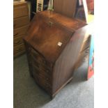 Mahogany Serpentine fronted Ladies Bureau with a fall front revealing a writing area and fitted