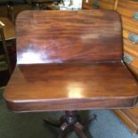 Regency period mahogany tea table with swivel action top revealing storage area below on 4 down