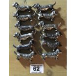 12 x assorted silver plated knife rests modelled as Dachshund, French probably 19's