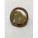 French Edwardian period circular brooch set with small diamond chip to the centre un-marked but