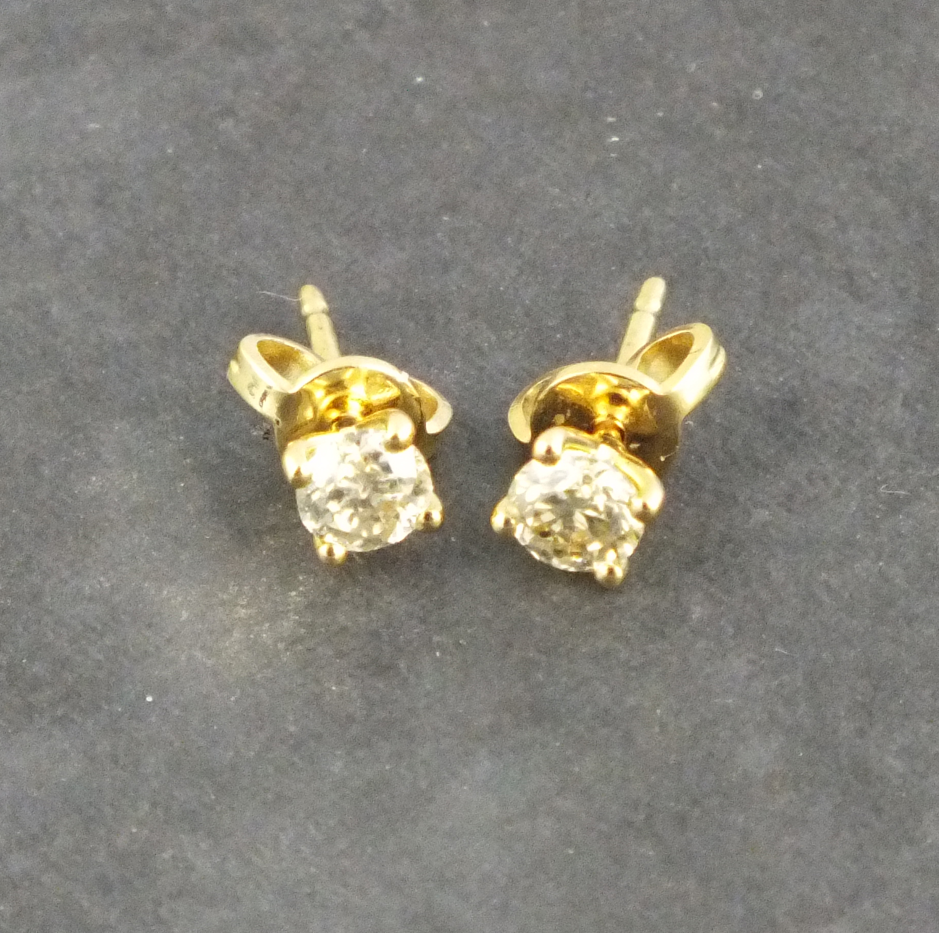 A pair of diamond ear studs, the brilliant cut stones approx. 0.62ct claw set in 18ct yellow gold,