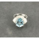 A large aquamarine and diamond set dress ring,  the oval central stone approx. 5.05ct, with a