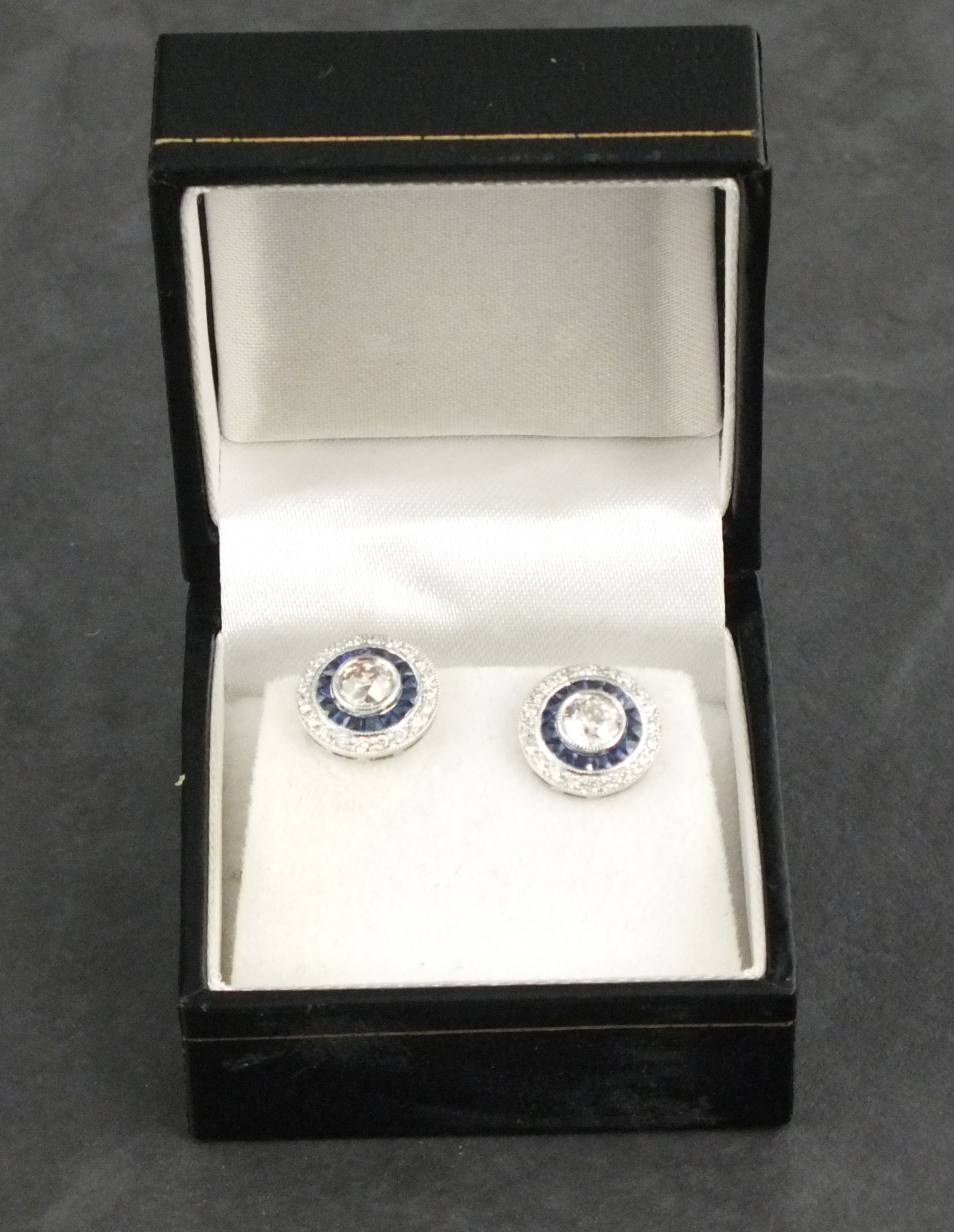 A pair of diamond and sapphire ear studs, target style, the central stones approx.. 0.90 ct, set - Image 2 of 2