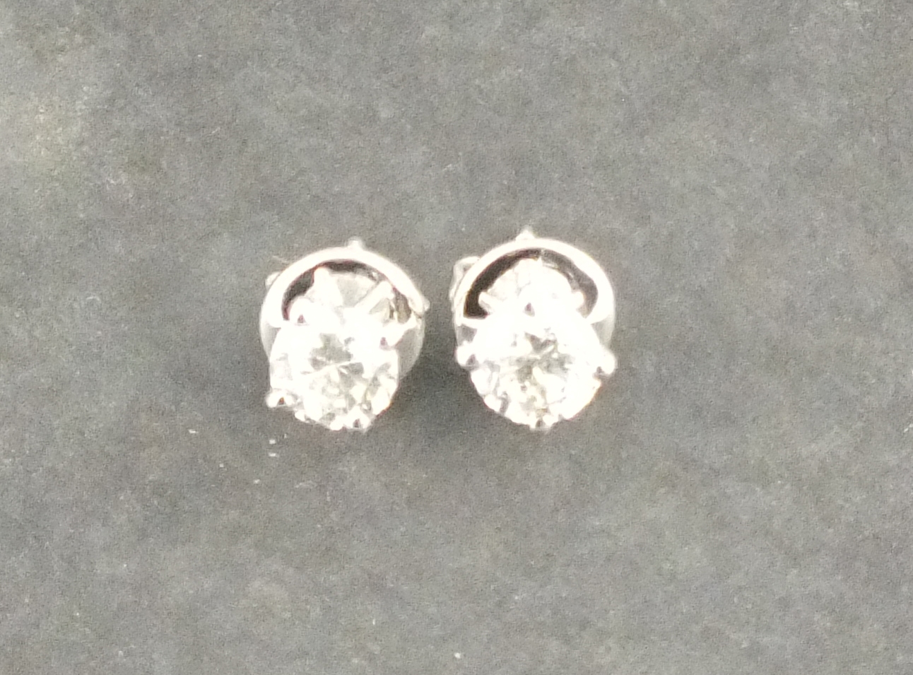 A pair of diamond ear studs, the brilliant cut stones claw set with 18ct white gold, 2gms