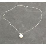 A pearl and diamond drop necklace, the peal with a 9ct white gold bail set with three diamonds, on a