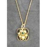 An Edwardian emerald and seed pearl pendant, the cluster on a rope twist round on a 9ct yellow