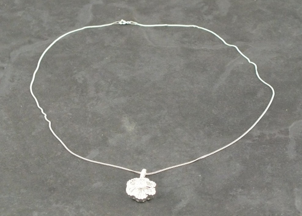 A diamond set pendant, floral set with an arrangement of brilliant and baguette cut stones,  approx.