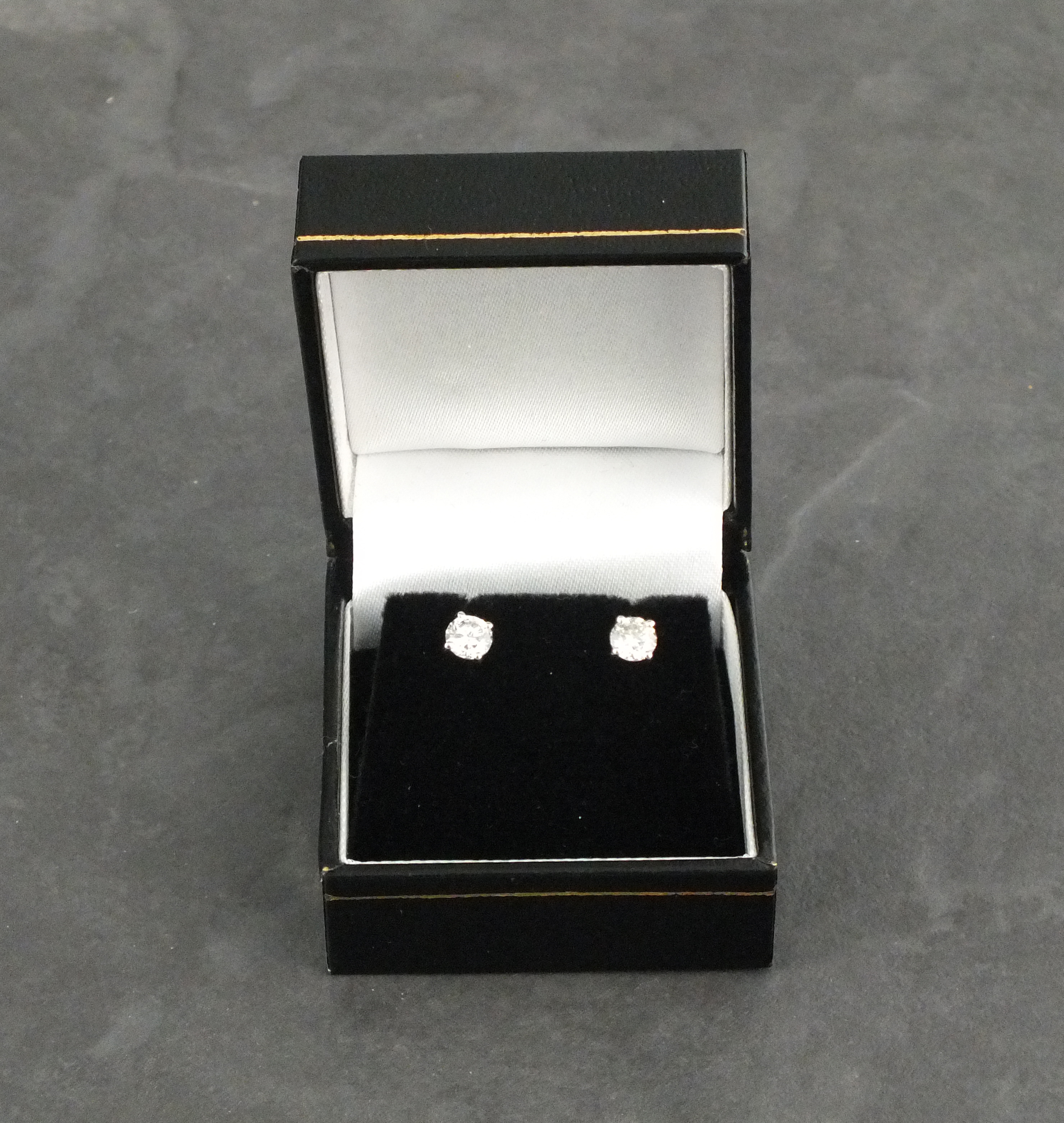 A pair of diamond ear studs, the brilliant cut stones claw set with 18ct white gold, 2gms - Image 2 of 2