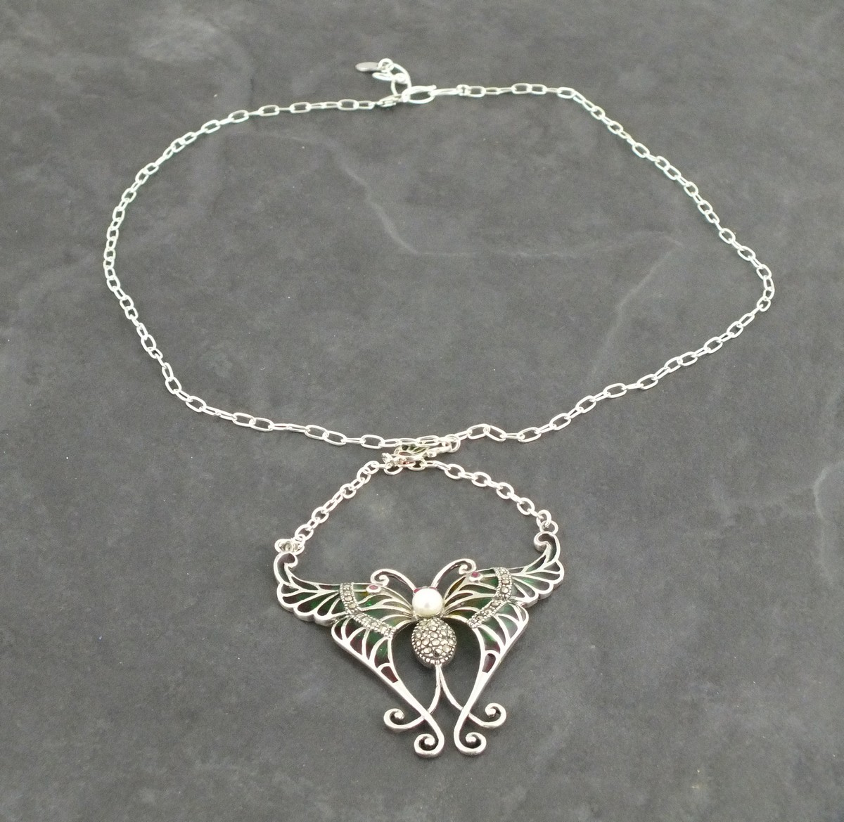 A plique-de-jour necklace, modelled in the form of a butterfly, with a pearl set to the centre, 16.
