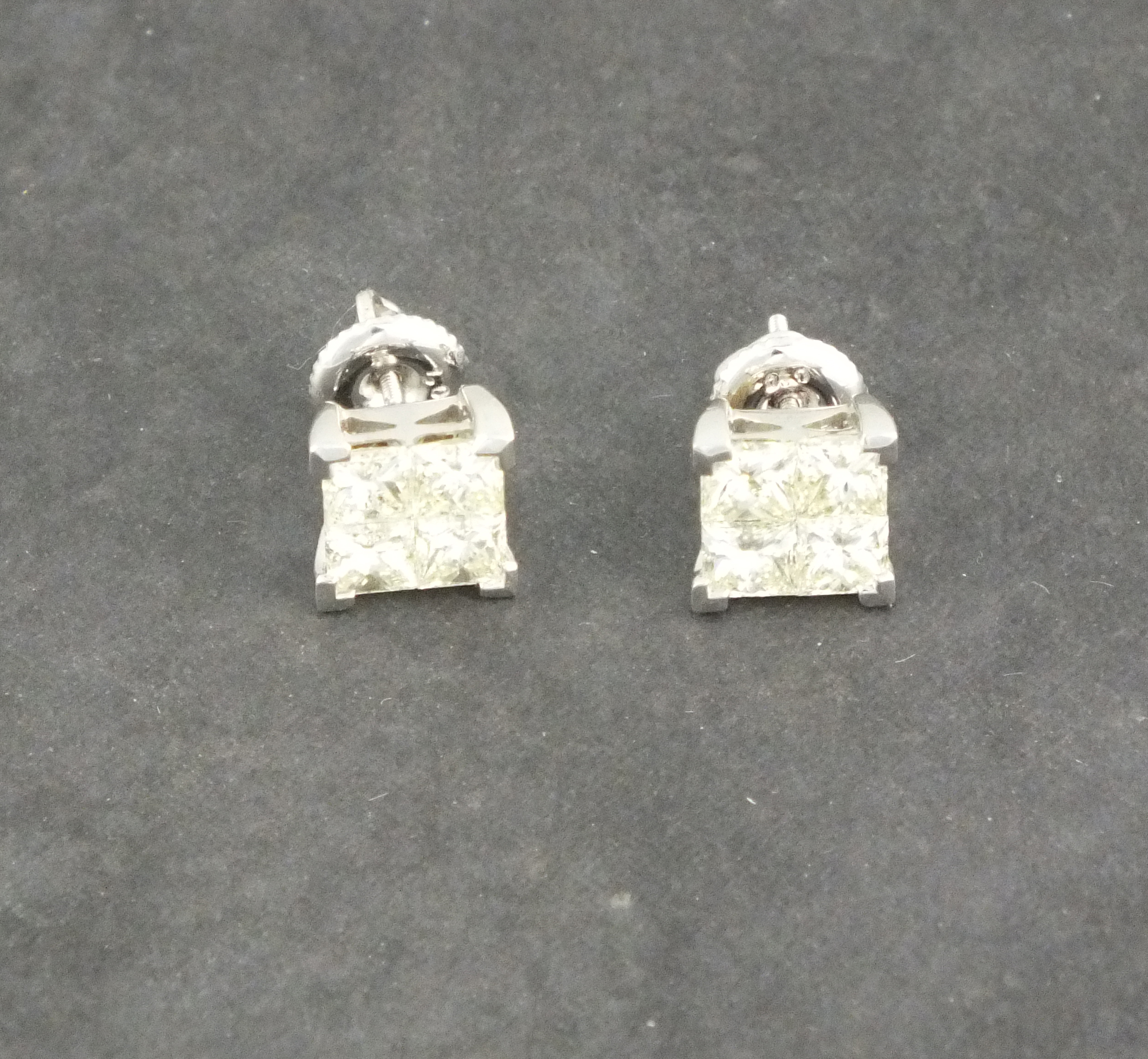 A pair of diamond ear studs, the princess cut stones (total weight approx. 2ct) in invisible pave