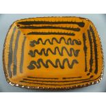 Newlyn Pottery dish, of a shallow square form, treacle glazed with linier decoration, impressed