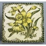 A late 19th Century tile, glazed and decorated with a daffodil, 6" x 6" (15cm x 15cm), together with