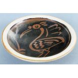 Seth CARDEW (British 1934-2016) Tenmoku glazed stoneware dish, decorated with a bird, 9.5" (24cm)