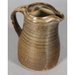 Leach Pottery standard ware jug, of typical ribbed form with a brown/green glaze, impressed mark