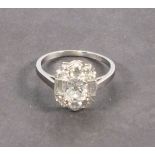 A platinum and diamond set dress ring, with a central oval old cut stone 1.16ct within an