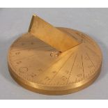 A brass sundial, calibrated for 55 degrees north, Newcastle, the engraved disc raised on a