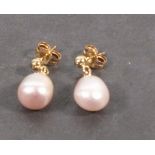 A pair of pearl drop ear studs, the pale pink pearls suspended from 9ct yellow gold studs