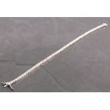 A diamond line bracelet, the round brilliant cut stones set in 18ct white gold, totaling 6.80ct,