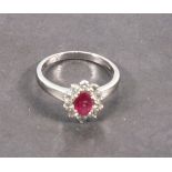 A ruby and diamond cluster ring, set in 18ct white gold, ruby 0.50ct, diamonds 0.50ct, together with
