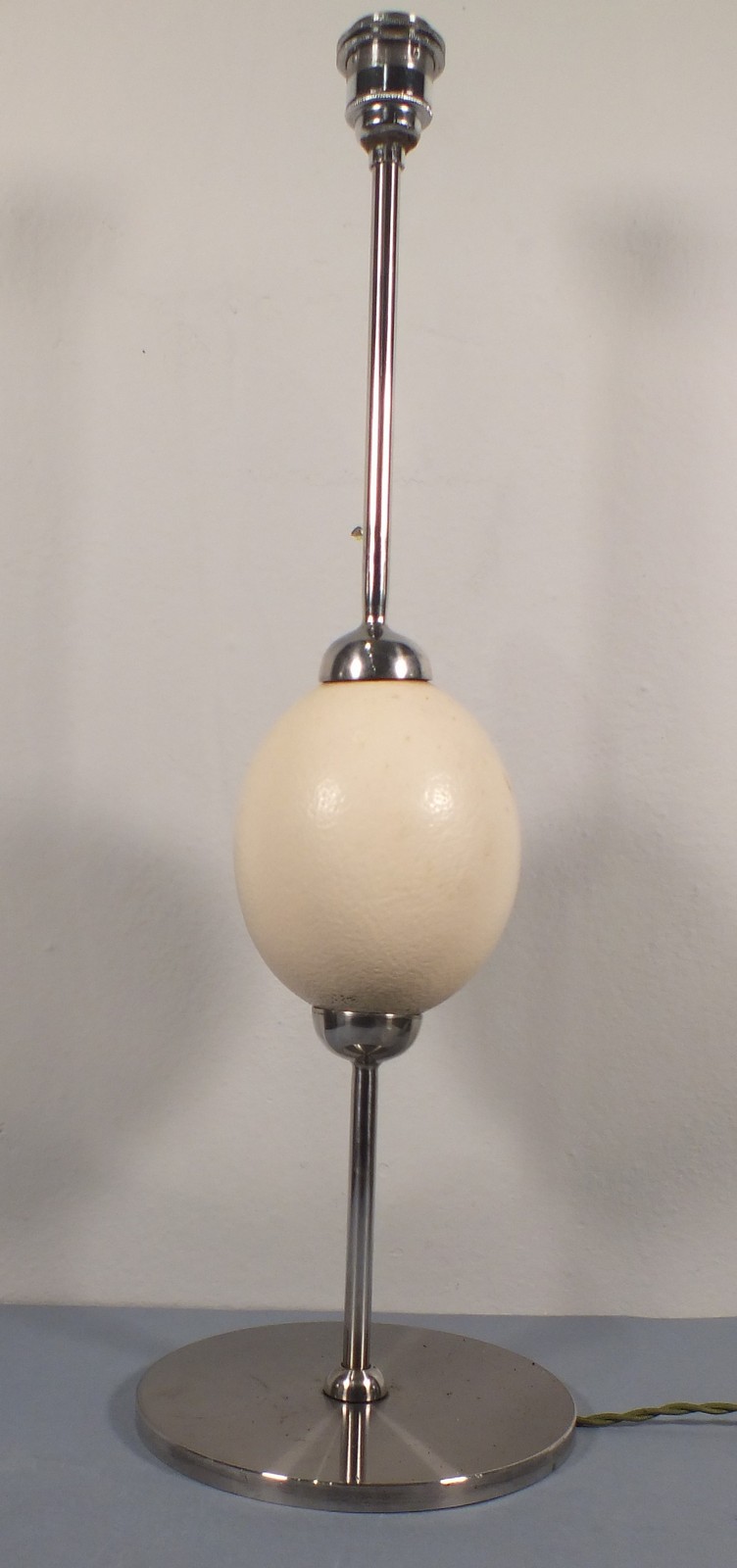 A contemporary desk lamp, of polished steel and incorporating an ostrich egg knop, 24.5" (62cm)