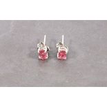 A pair of pink tourmaline eat studs, the oval cut stones claw set in sliver