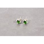 A pair of diopside ear studs, the oval stones claw set within silver