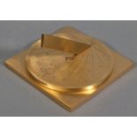 A brass sundial, calibrated for 34 degrees south, Cape Town, the engraved disc raised on a square