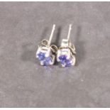 A pair of tanzanite ear studs,  the oval stones claw set in silver